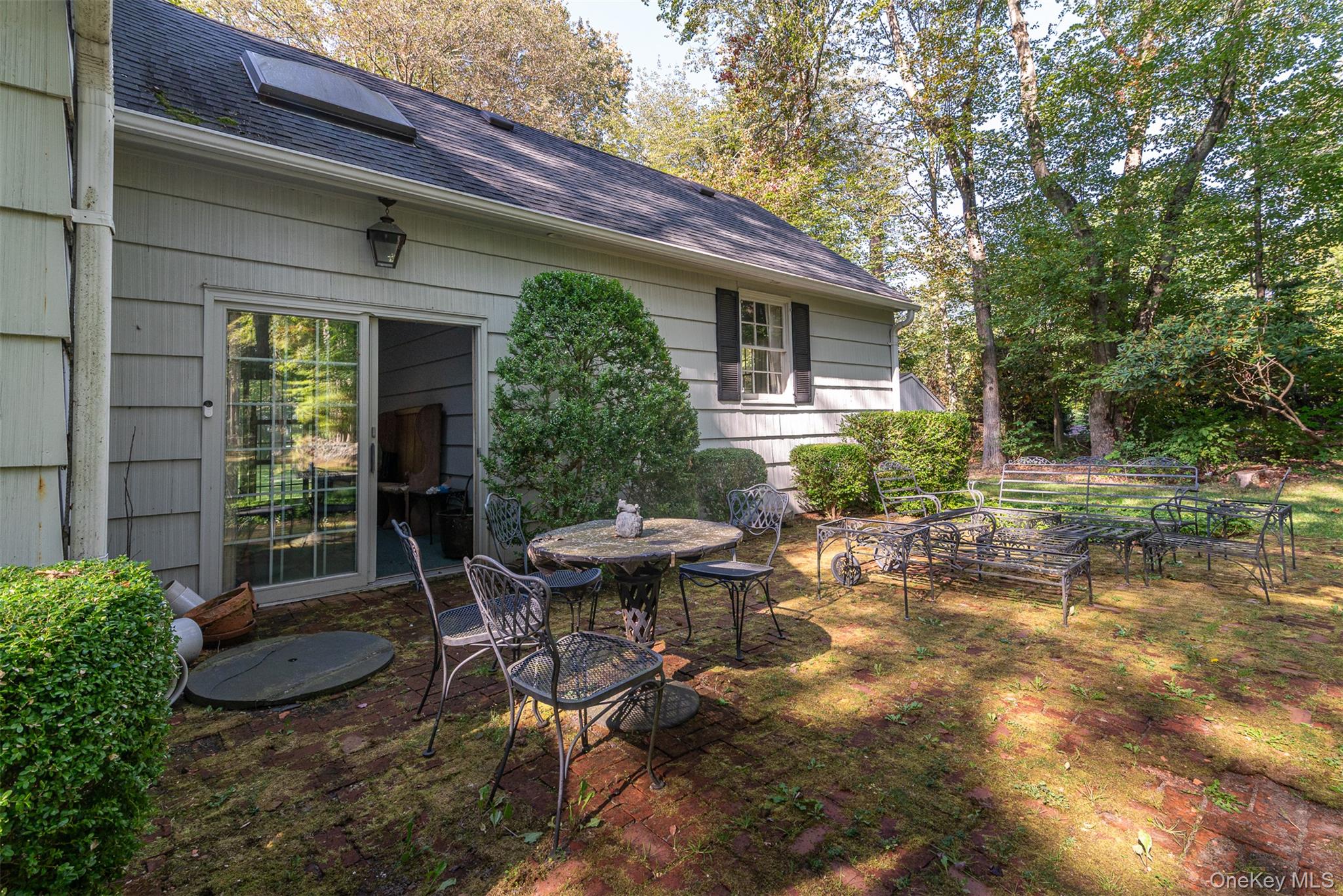 5 Hadley Road Armonk, NY 10504 - Photo 12 of 18 a view of a house with backyard sitting area and garden