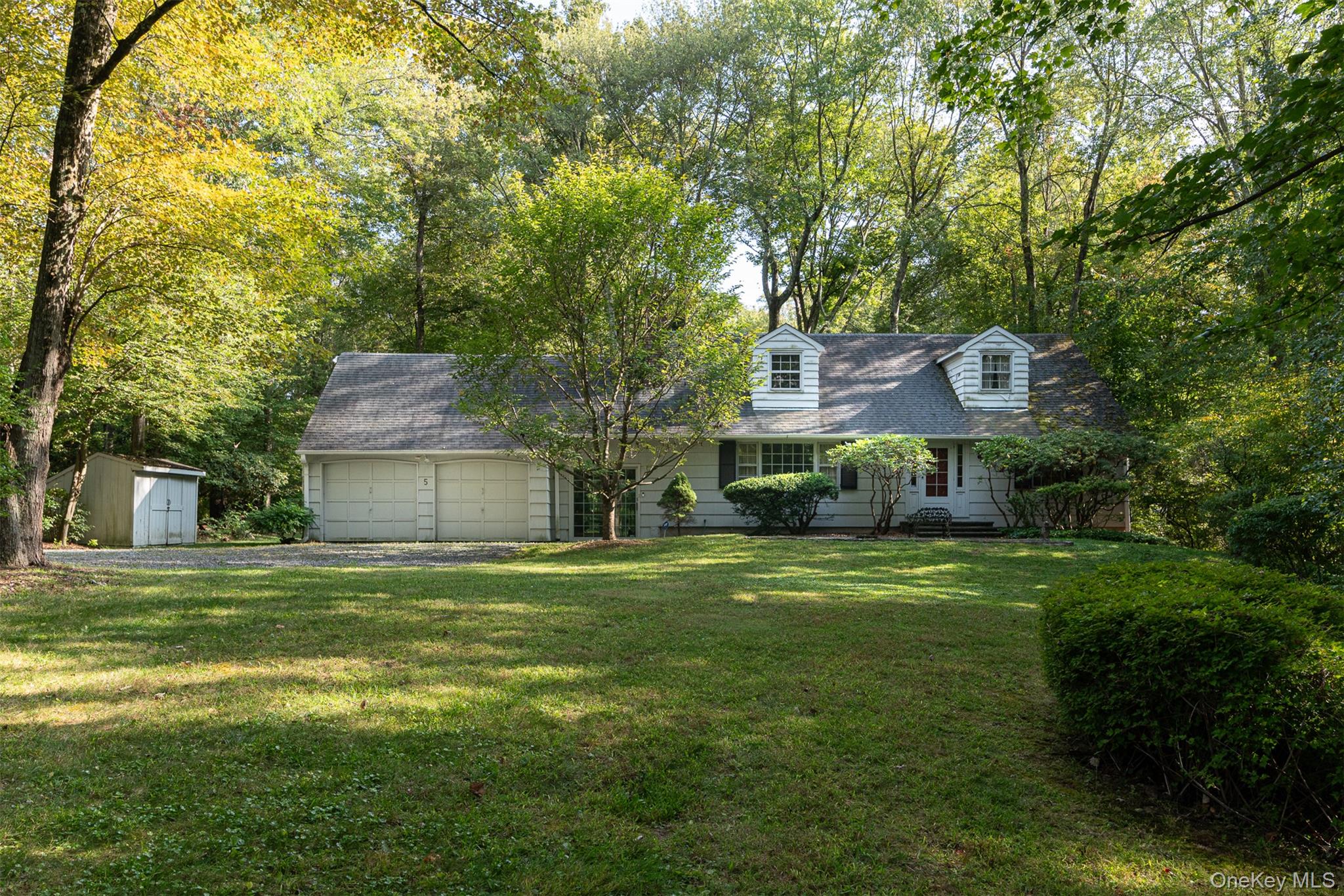 5 Hadley Road Armonk, NY 10504 - Photo 3 of 18 a front view of a house with a garden