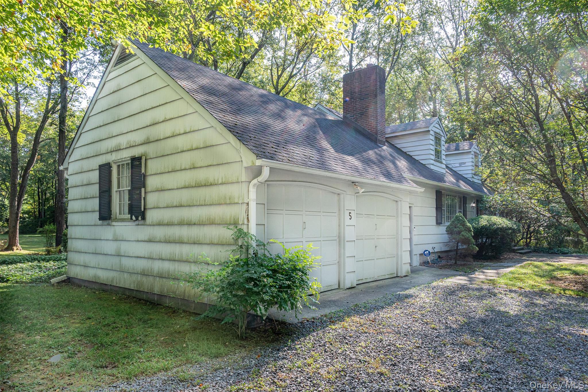5 Hadley Road Armonk, NY 10504 - Photo 4 of 18 a front view of a house with a yard