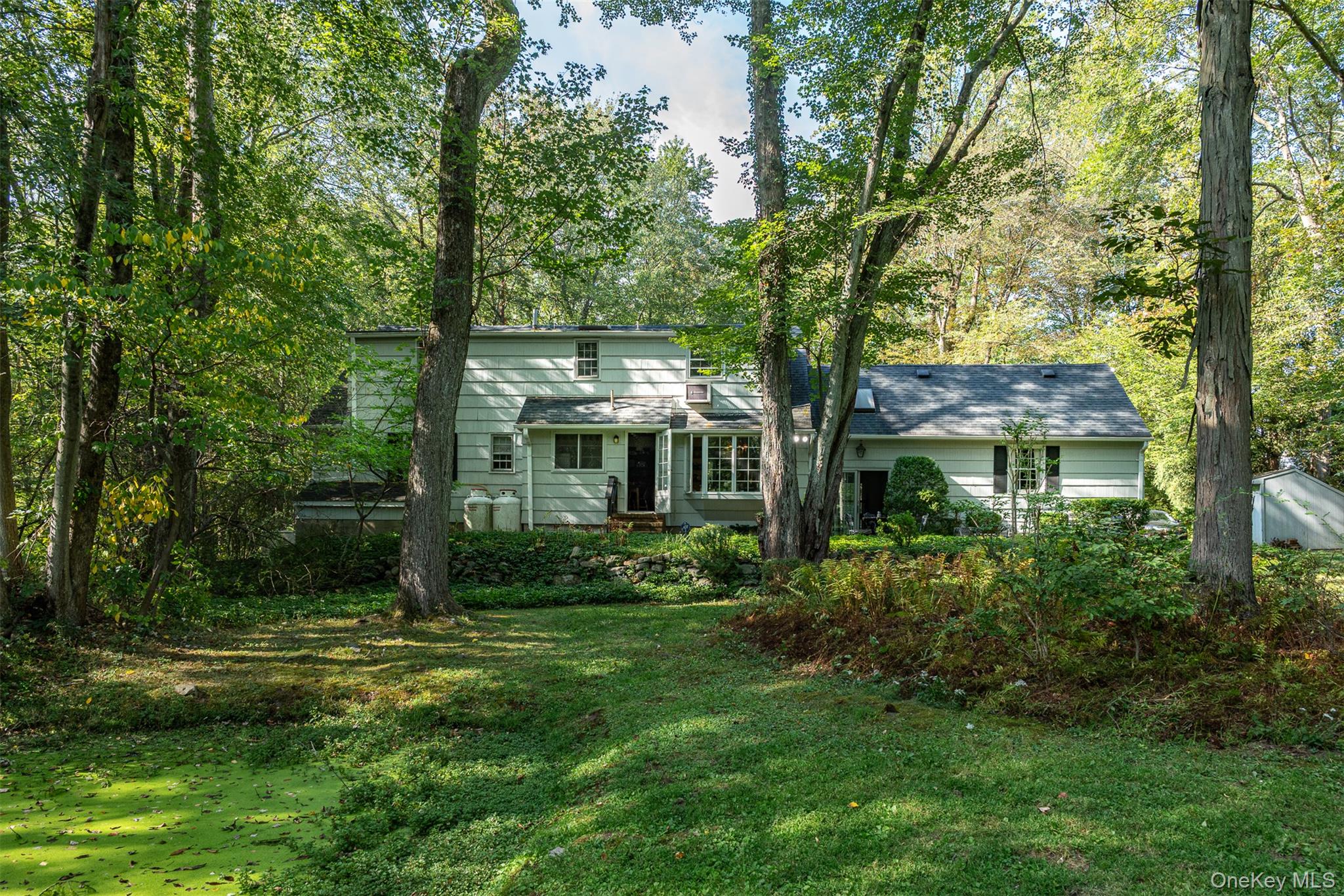 5 Hadley Road Armonk, NY 10504 - Photo 7 of 18 a front view of a house with garden