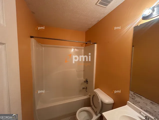 a bathroom with a shower a toilet and a shower