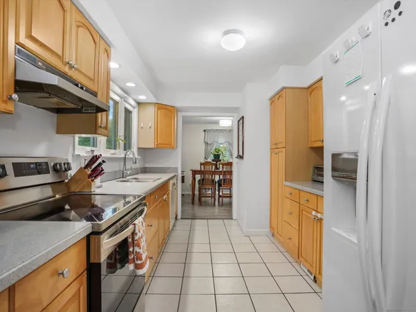 a kitchen with stainless steel appliances granite countertop a stove and a refrigerator