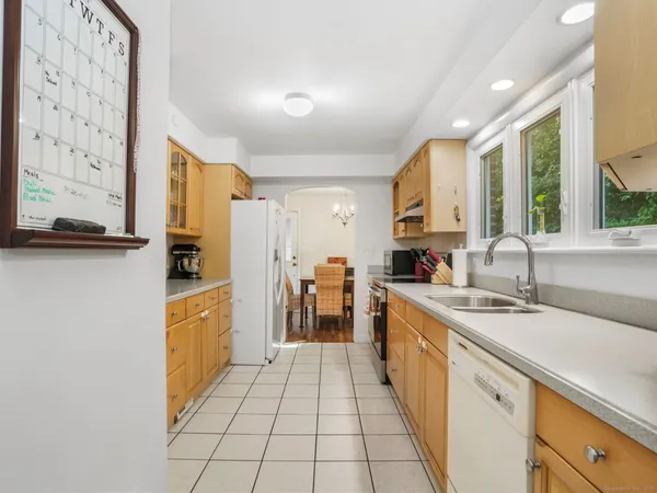 a large kitchen with stainless steel appliances granite countertop a sink and cabinets