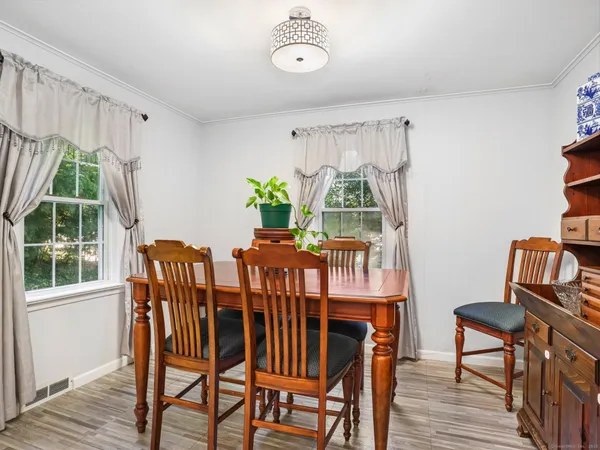 a view of a dining room with furniture window and wooden floor
