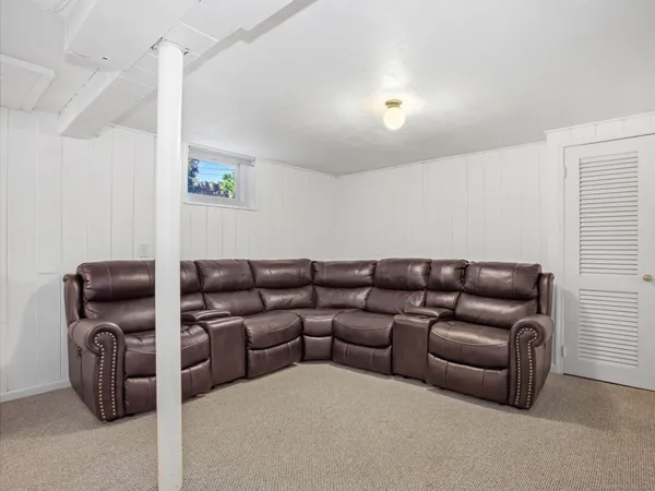 a living room with furniture and a projector screen