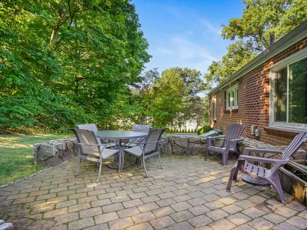 a view of a patio with table and chairs and potted plants