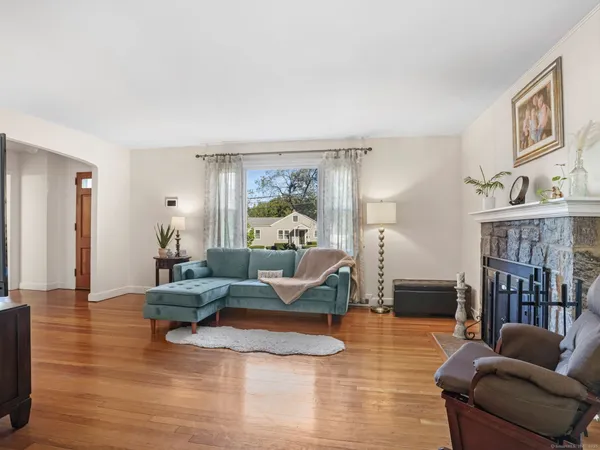 a living room with furniture or couch and a wooden floor