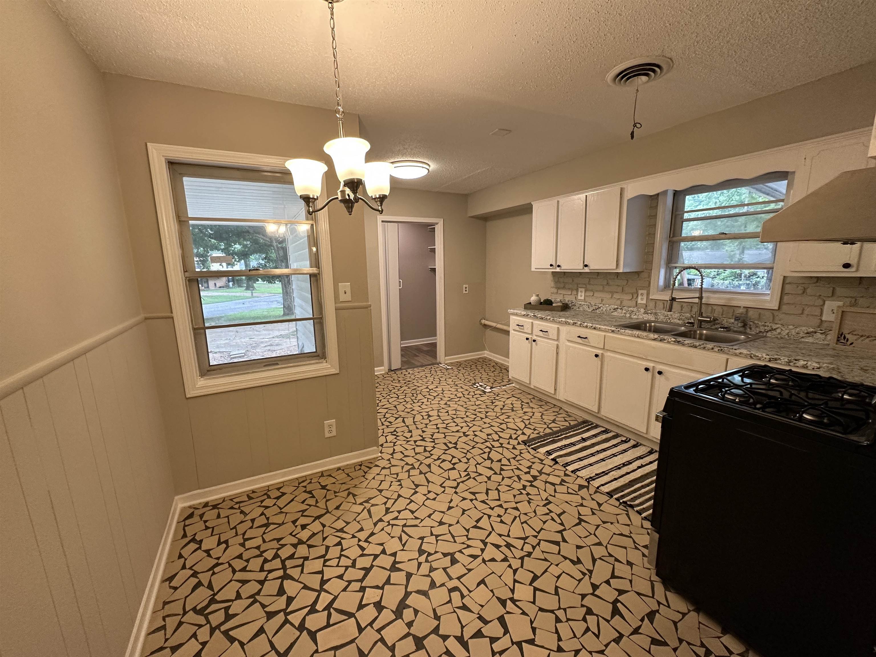 1594 Winfield Road Memphis, TN 38116 - Photo 12 of 29 a kitchen with stainless steel appliances granite countertop a sink stove and refrigerator