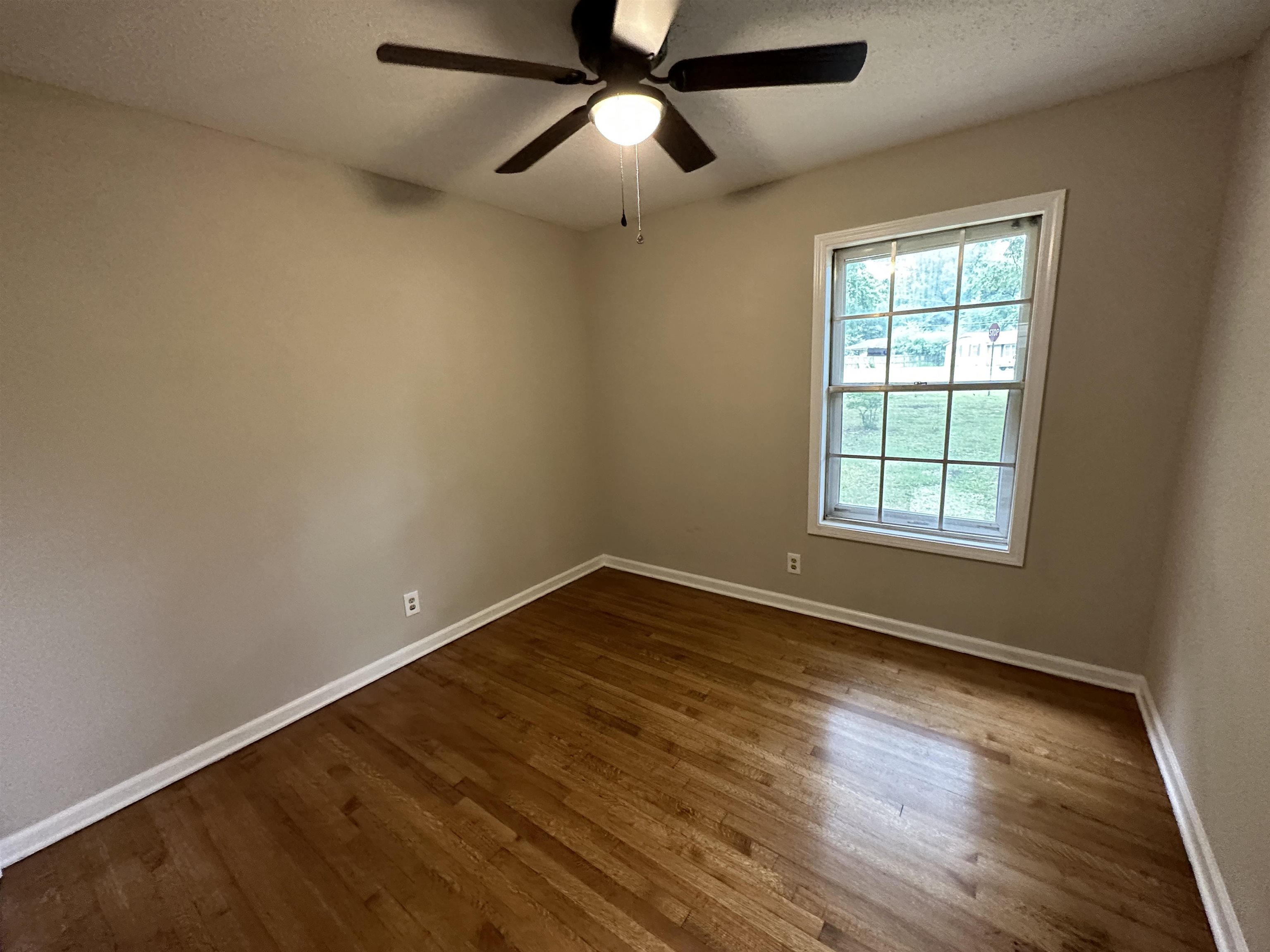 1594 Winfield Road Memphis, TN 38116 - Photo 18 of 29 wooden floor in an empty room with a window