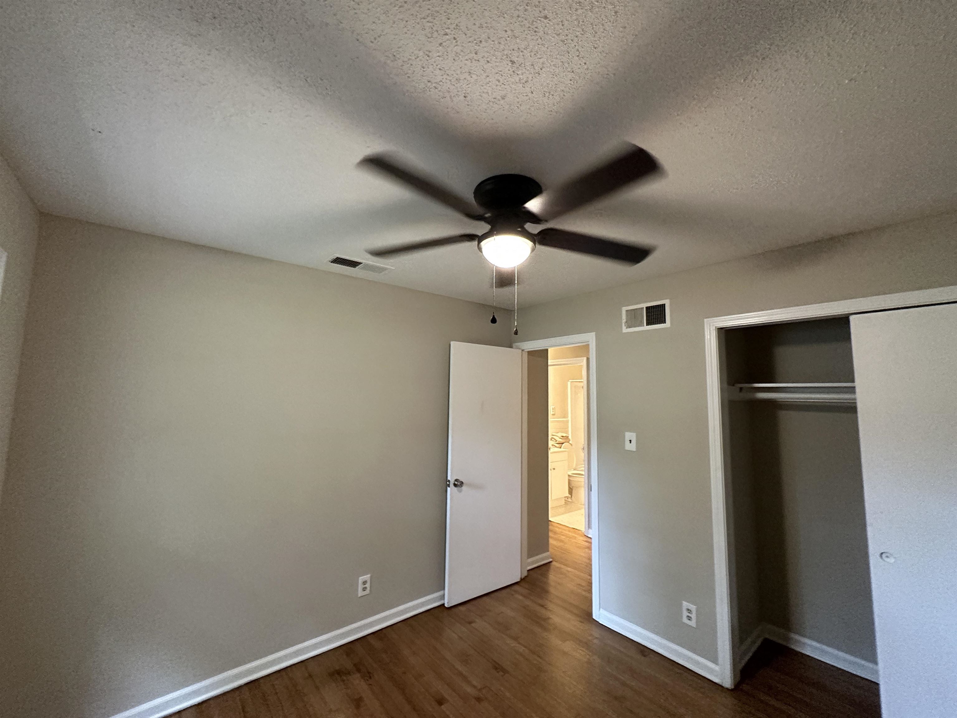 1594 Winfield Road Memphis, TN 38116 - Photo 20 of 29 an empty room with wooden floor closet and ceiling fan