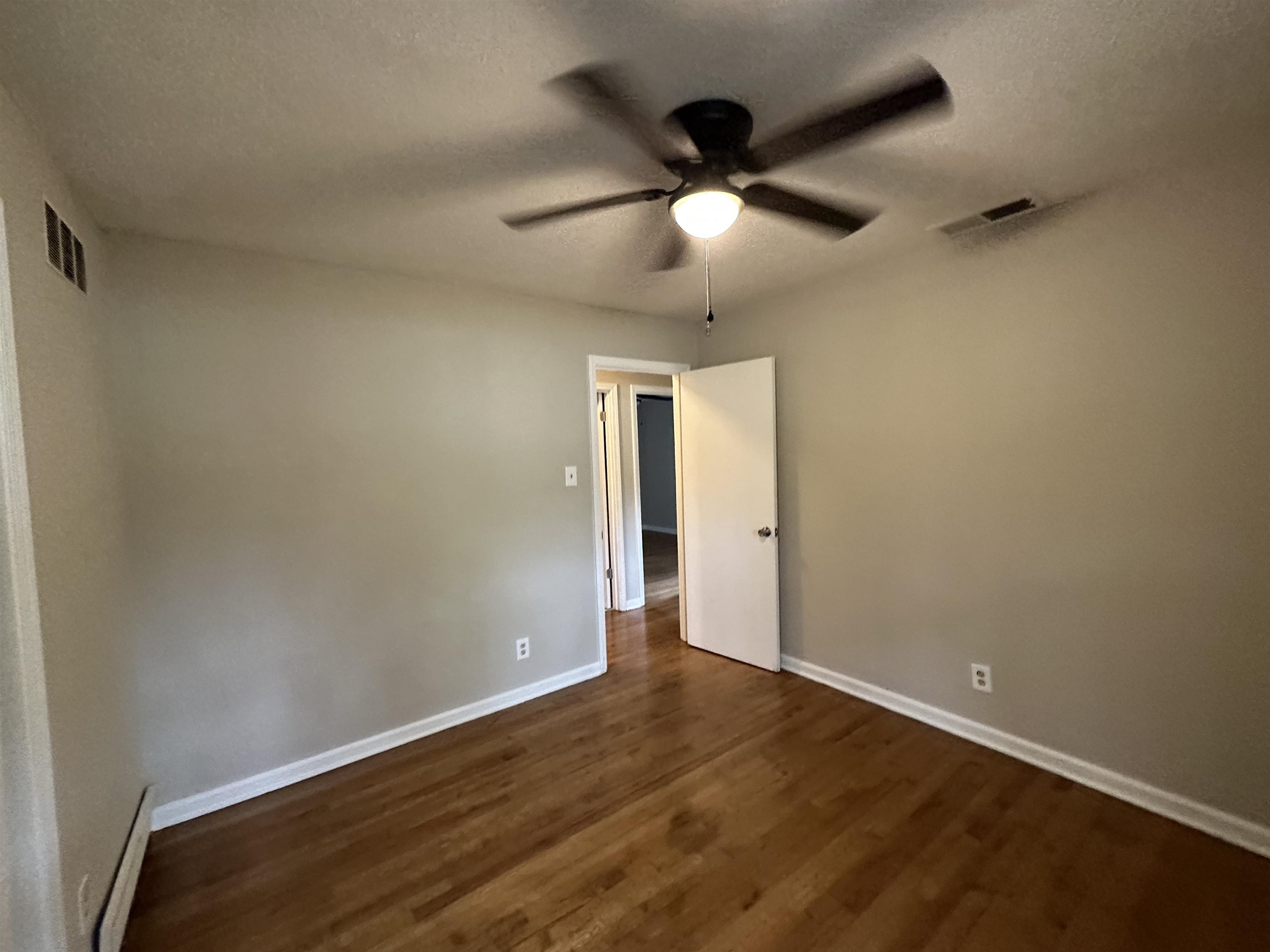 1594 Winfield Road Memphis, TN 38116 - Photo 23 of 29 an empty room with wooden floor and windows