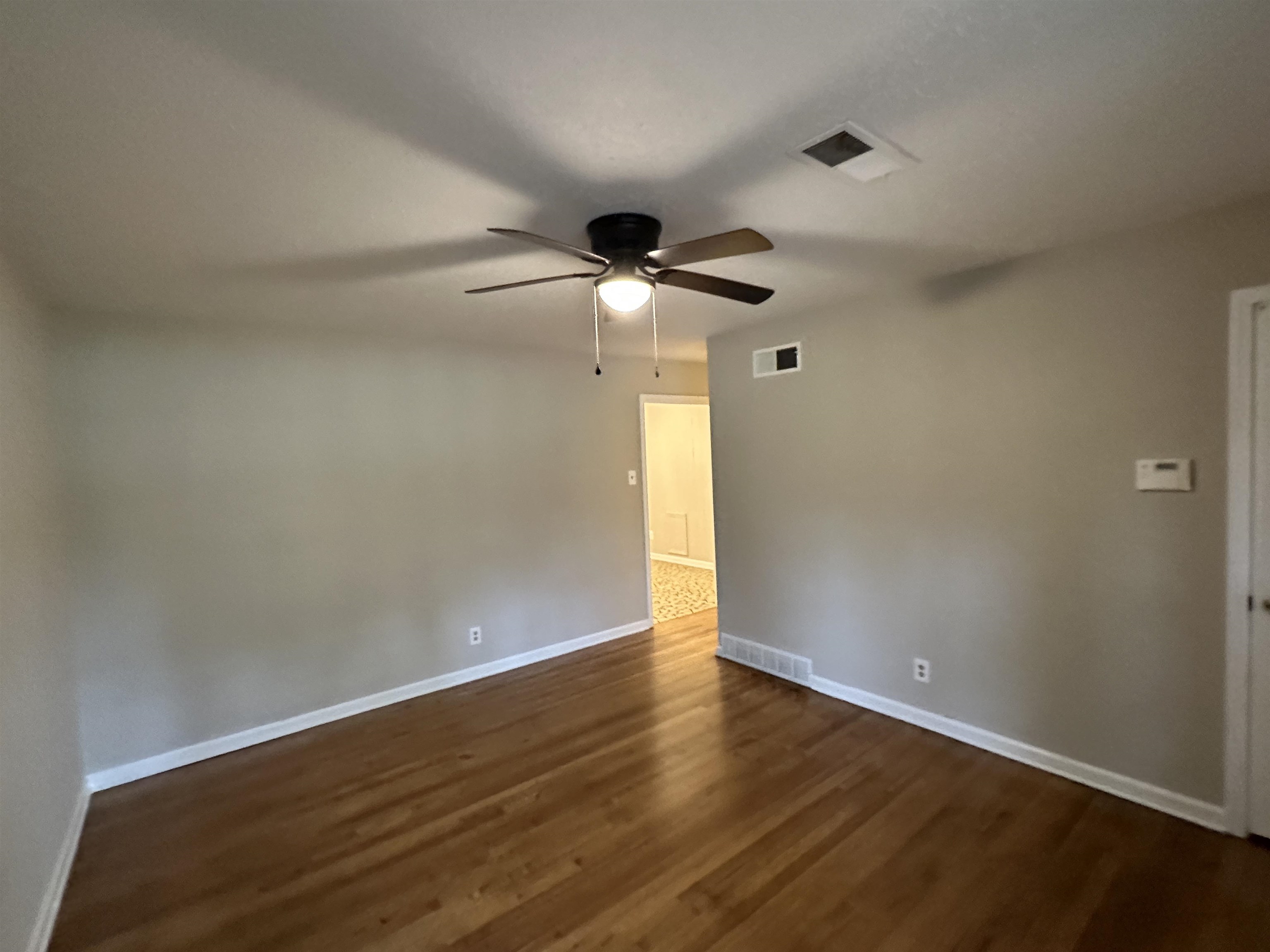 1594 Winfield Road Memphis, TN 38116 - Photo 4 of 29 a view of an empty room with wooden floor