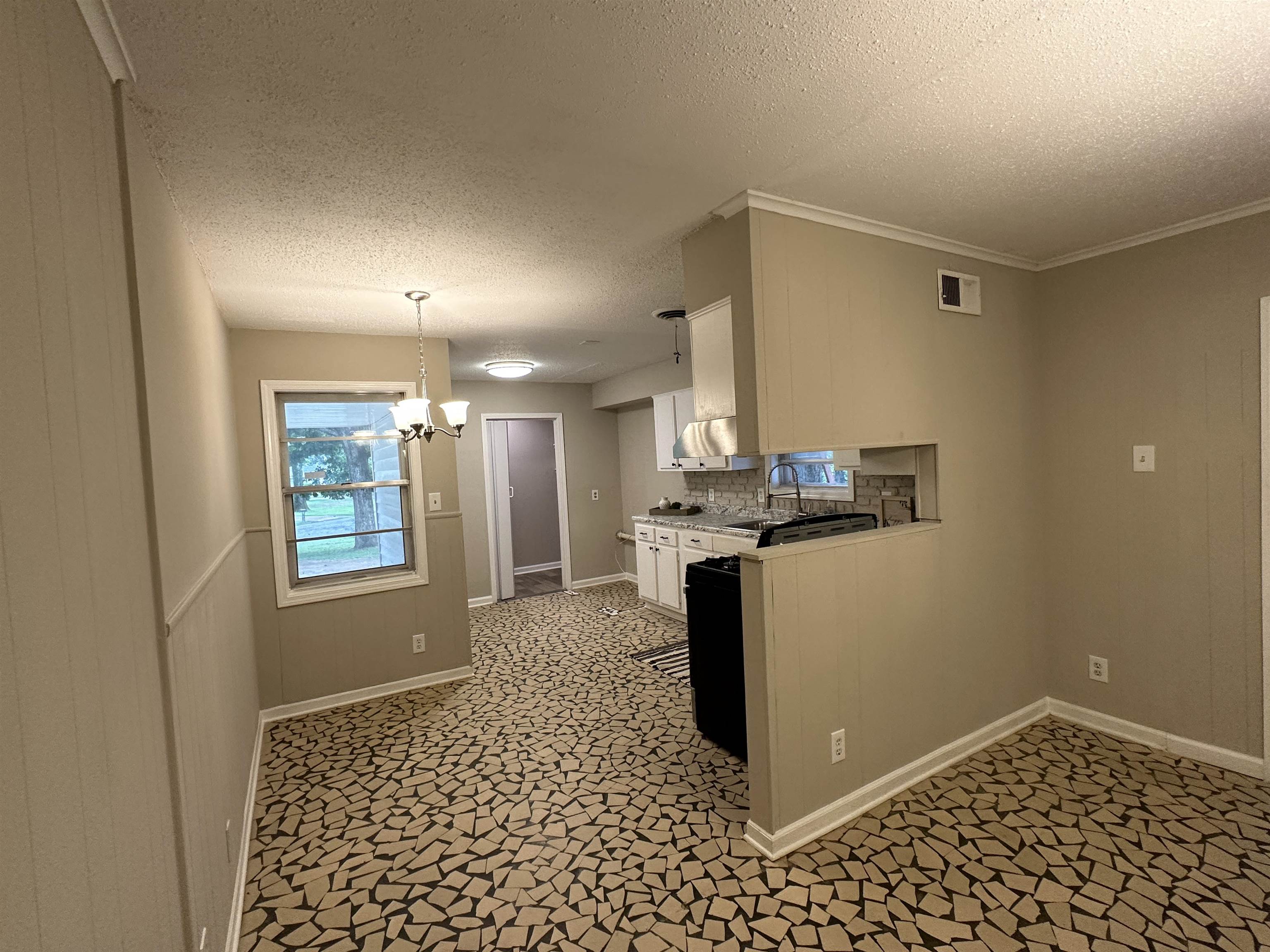 1594 Winfield Road Memphis, TN 38116 - Photo 8 of 29 a kitchen with a refrigerator and a stove top oven
