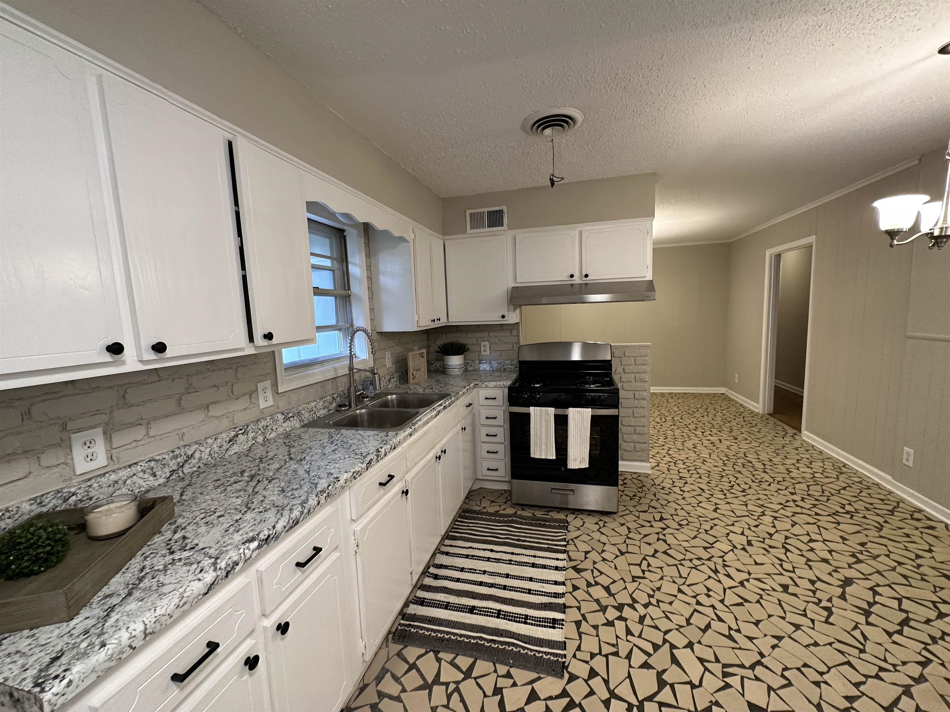 1594 Winfield Road Memphis, TN 38116 - Photo 10 of 29 a kitchen with granite countertop a stove a sink and a granite counter tops