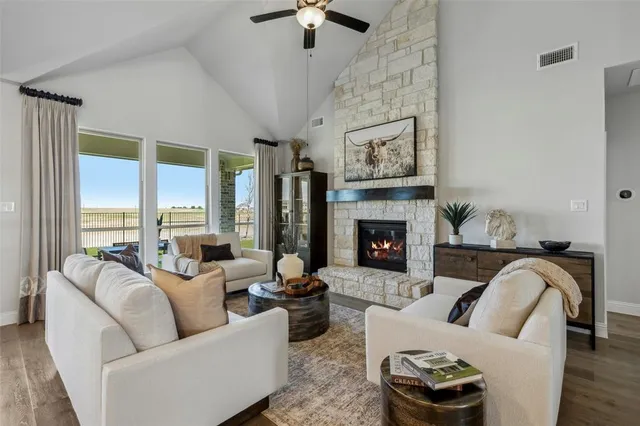a kitchen with stainless steel appliances a dining table chairs stove and white cabinets