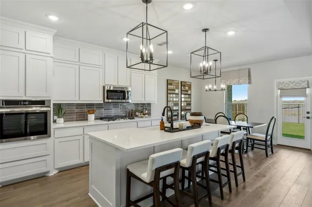a kitchen with lots of counter top space and stainless steel appliances