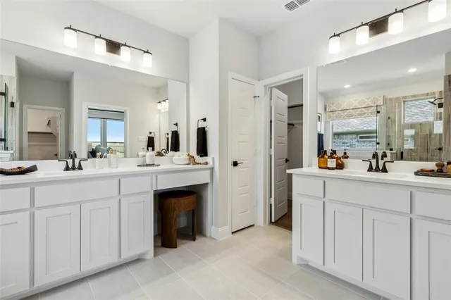 a spacious bathroom with a shower sink and mirror