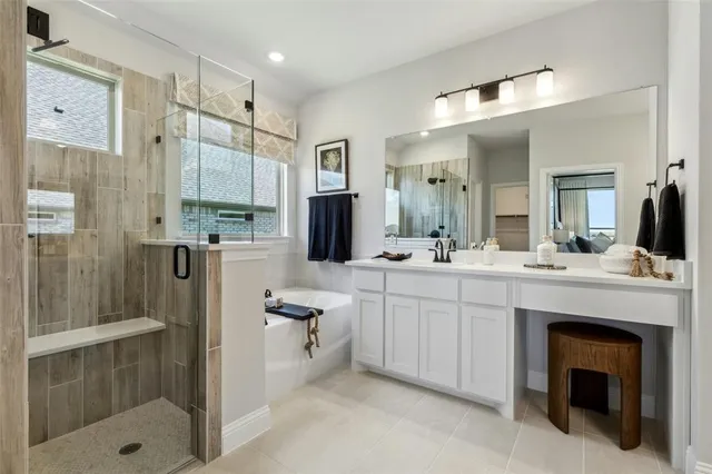 a bathroom with a double vanity sink toilet and shower