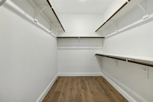 a dining room with furniture a chandelier and wooden floor