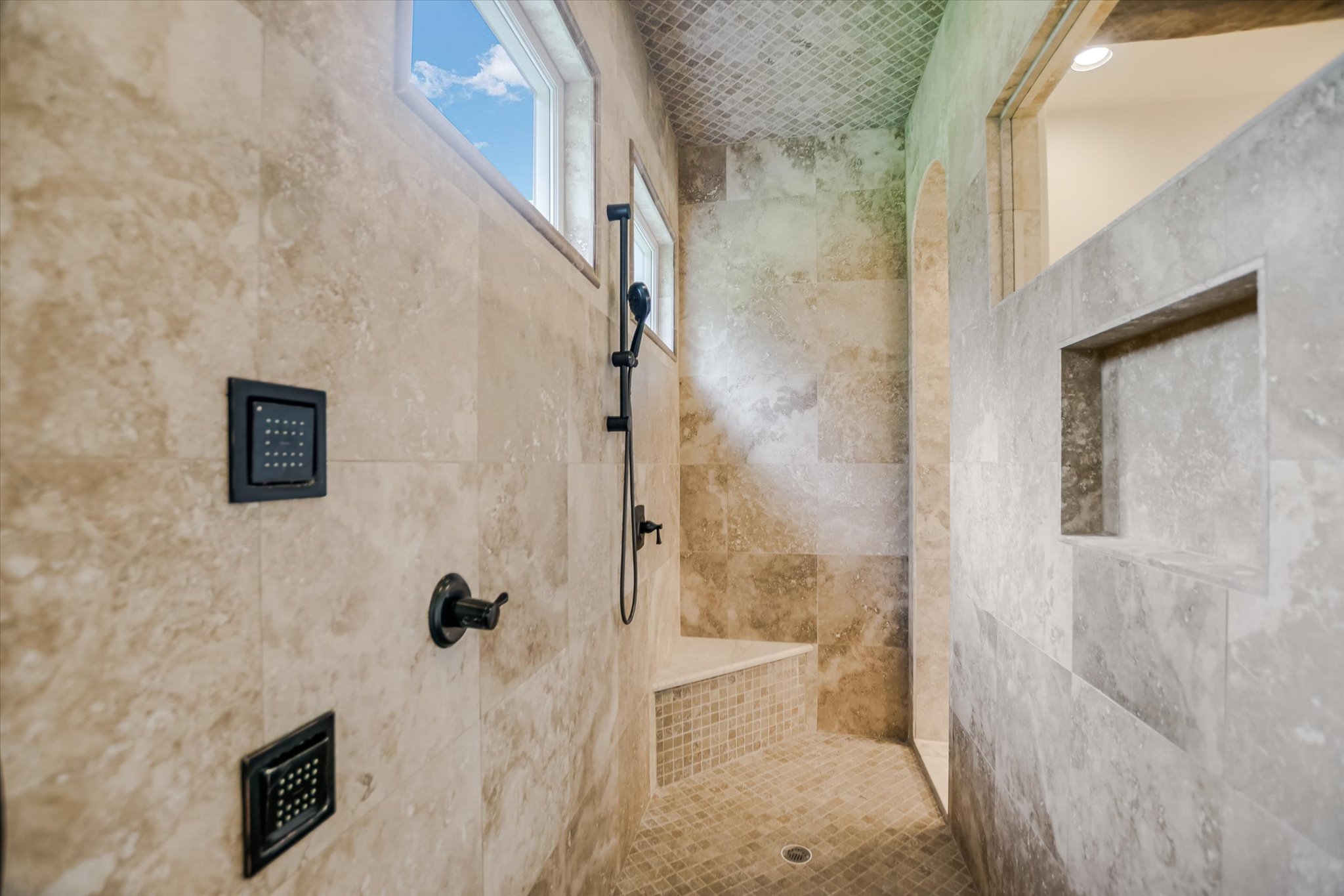 11 Inwood Circle Austin, TX 78746 - Photo 20 of 38 Indulge in a spa-like bathing experience within this generously tiled shower enclosure, complete with integrated seating.
