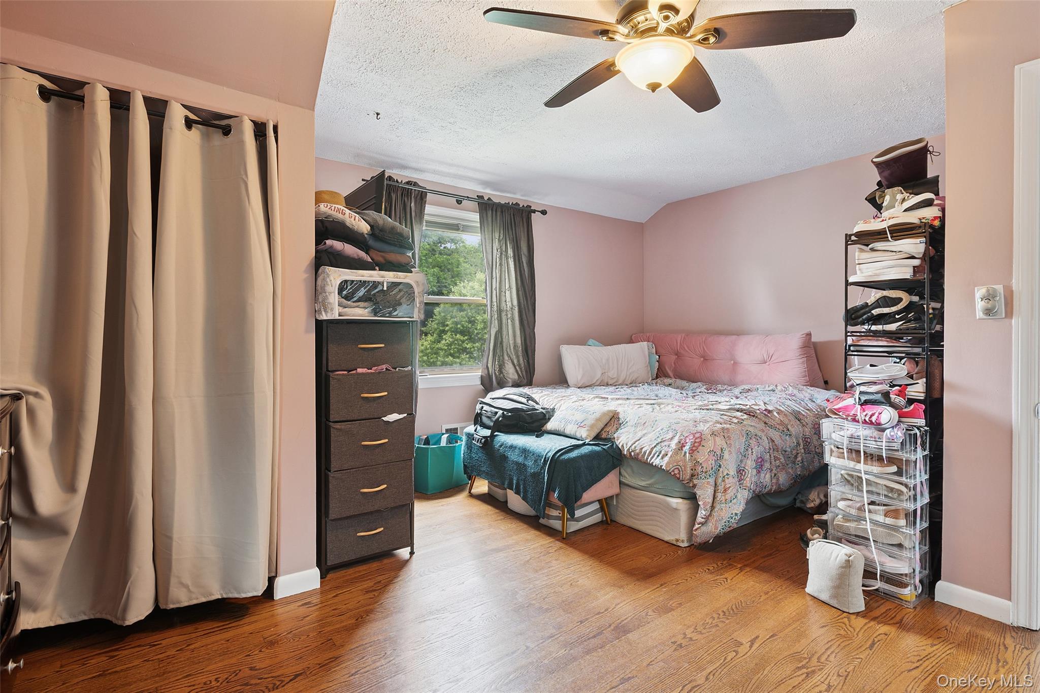 69 Ardell Road Bronxville, NY 10708 - Photo 25 of 48 a bedroom with a bed and a walk in closet with wooden floor