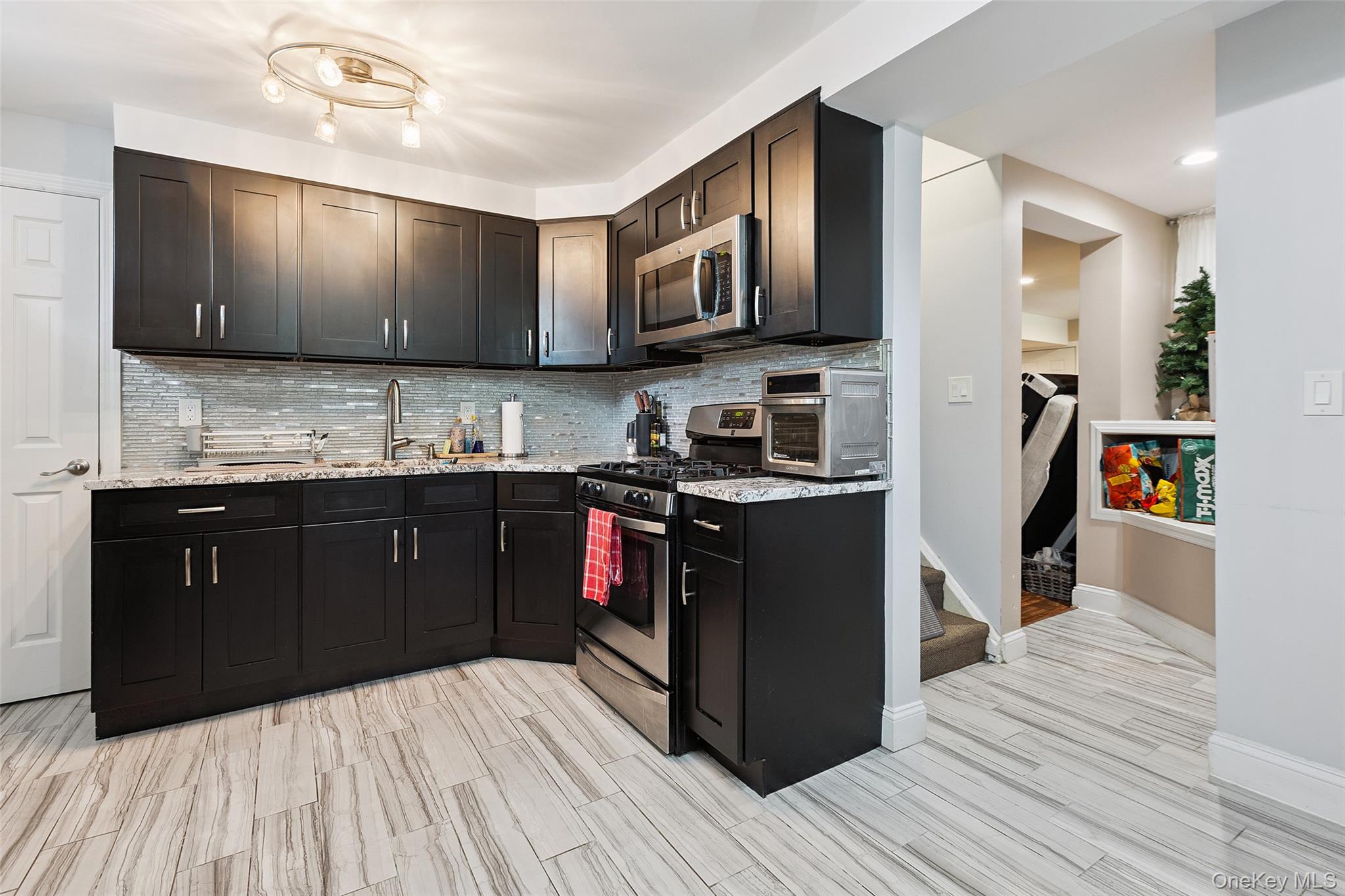 69 Ardell Road Bronxville, NY 10708 - Photo 32 of 48 a kitchen with stainless steel appliances granite countertop a stove a sink and a refrigerator