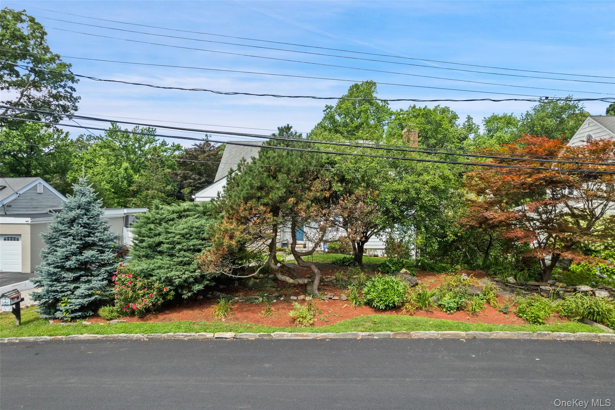 69 Ardell Road Bronxville, NY 10708 - Photo 45 of 48 a backyard of a house with a yard and outdoor seating