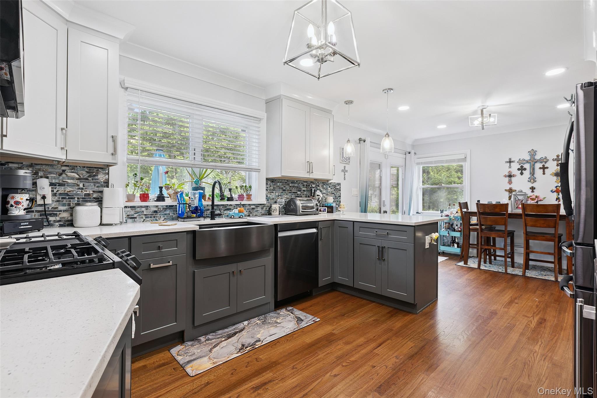 69 Ardell Road Bronxville, NY 10708 - Photo 7 of 48 a kitchen with stainless steel appliances granite countertop wooden cabinets a stove a sink a dining table and chairs