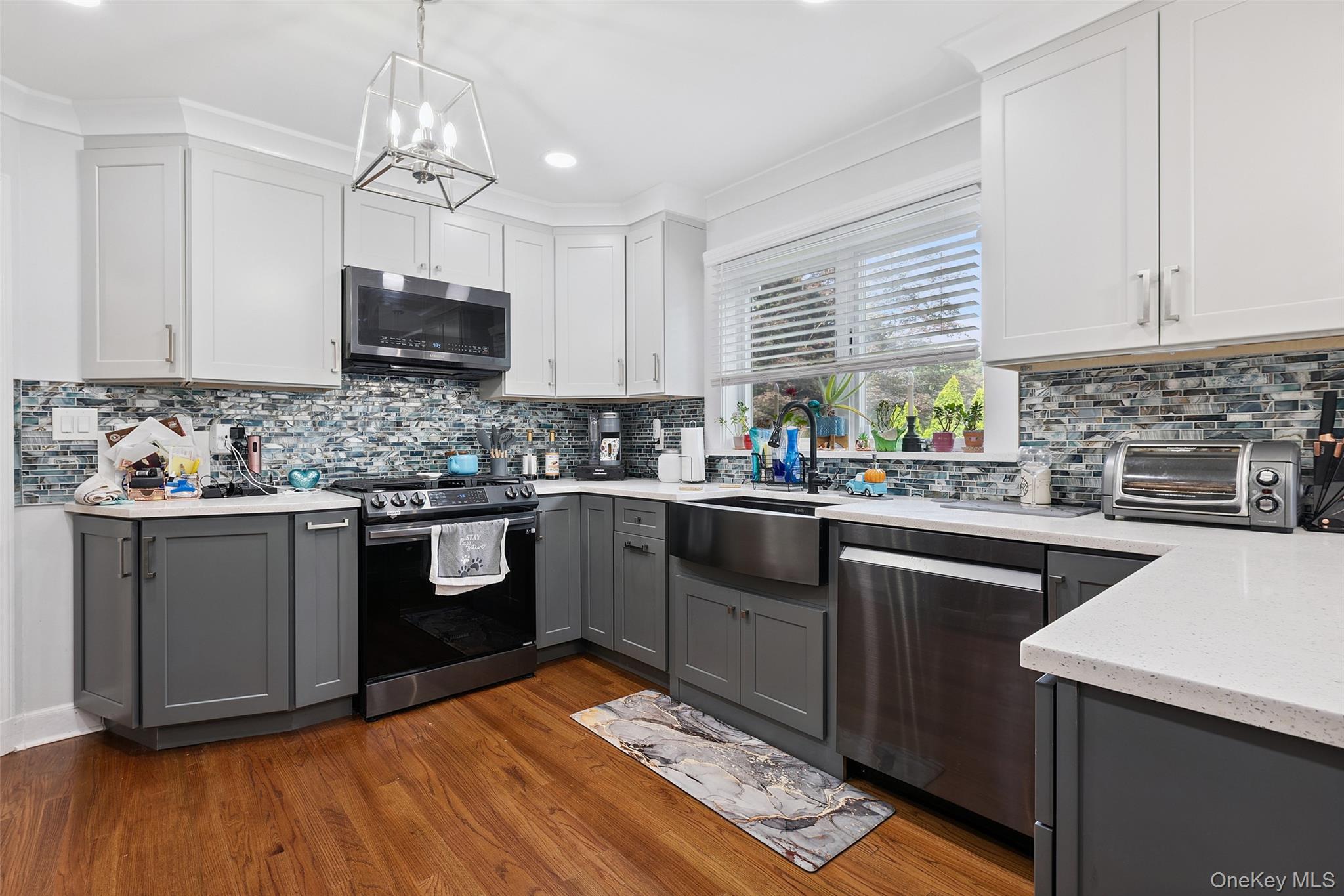 69 Ardell Road Bronxville, NY 10708 - Photo 9 of 48 a kitchen with stainless steel appliances kitchen island granite countertop a sink cabinets and wooden floor