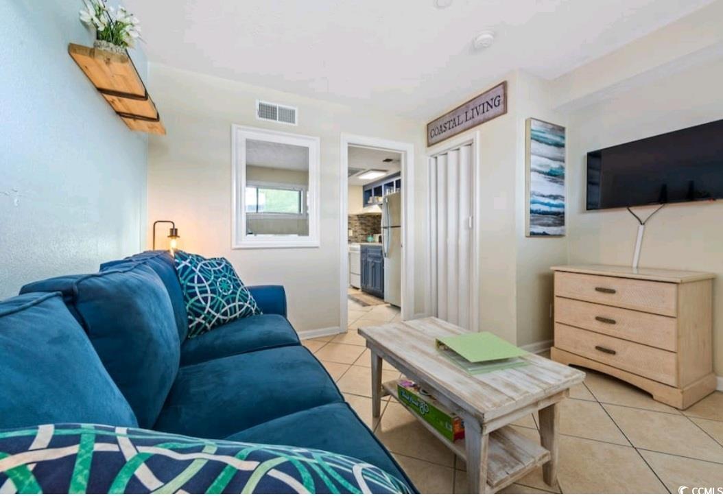 2000 South Ocean Boulevard, Unit V207AB Myrtle Beach, SC 29577 - Photo 6 of 11 Living area featuring light tile patterned flooring and baseboards