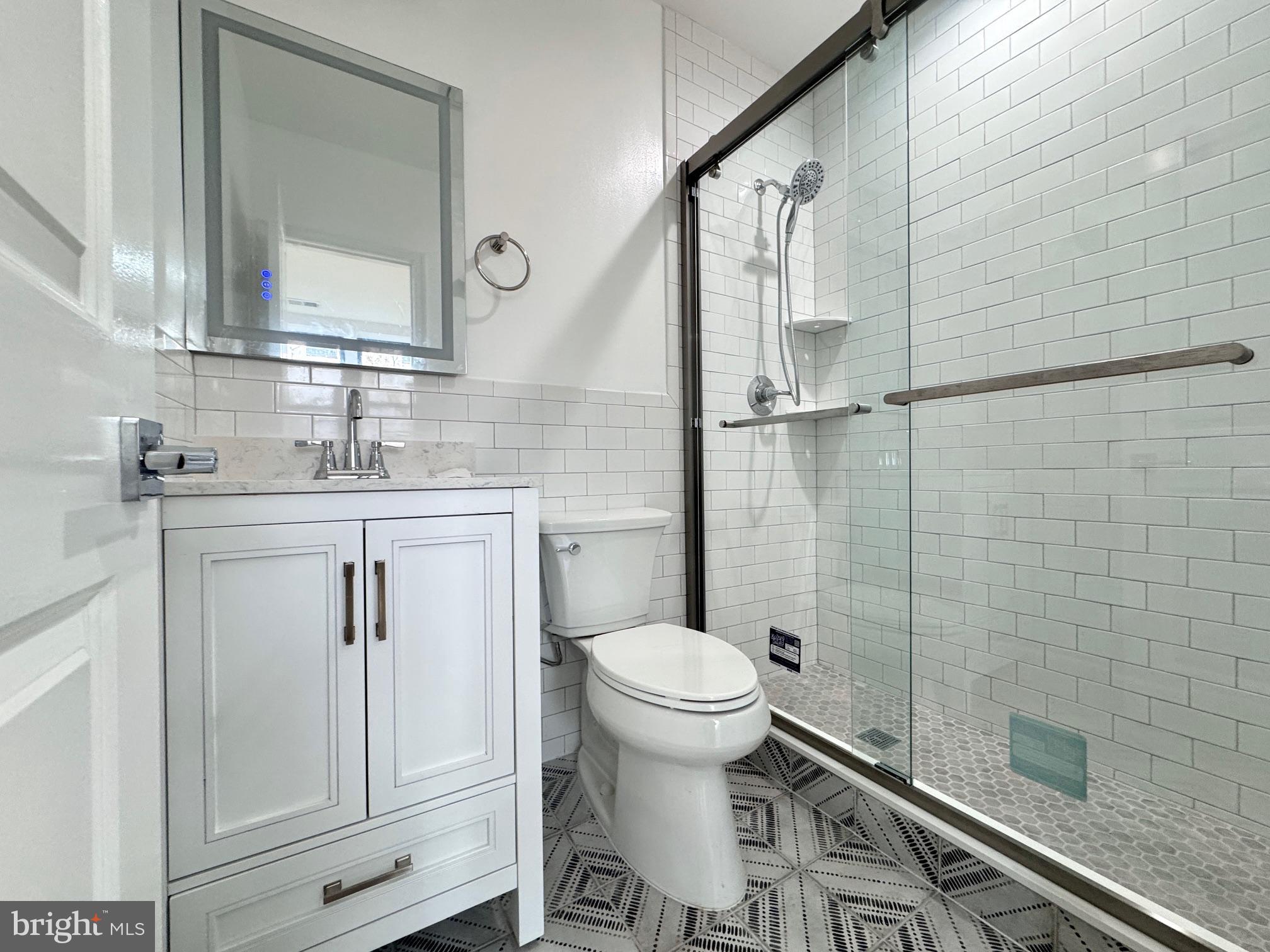 781 South 3rd Street, Unit 3 Philadelphia, PA 19147 - Photo 12 of 17 a bathroom with a granite countertop sink toilet and shower