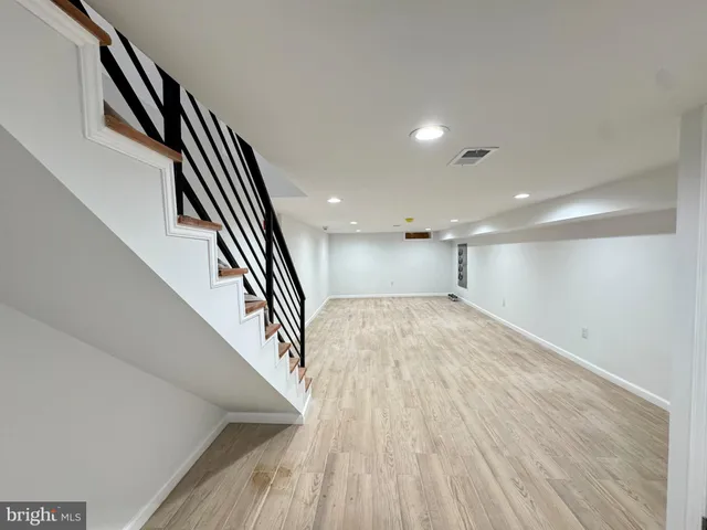 an entryway in a hall with wooden floor