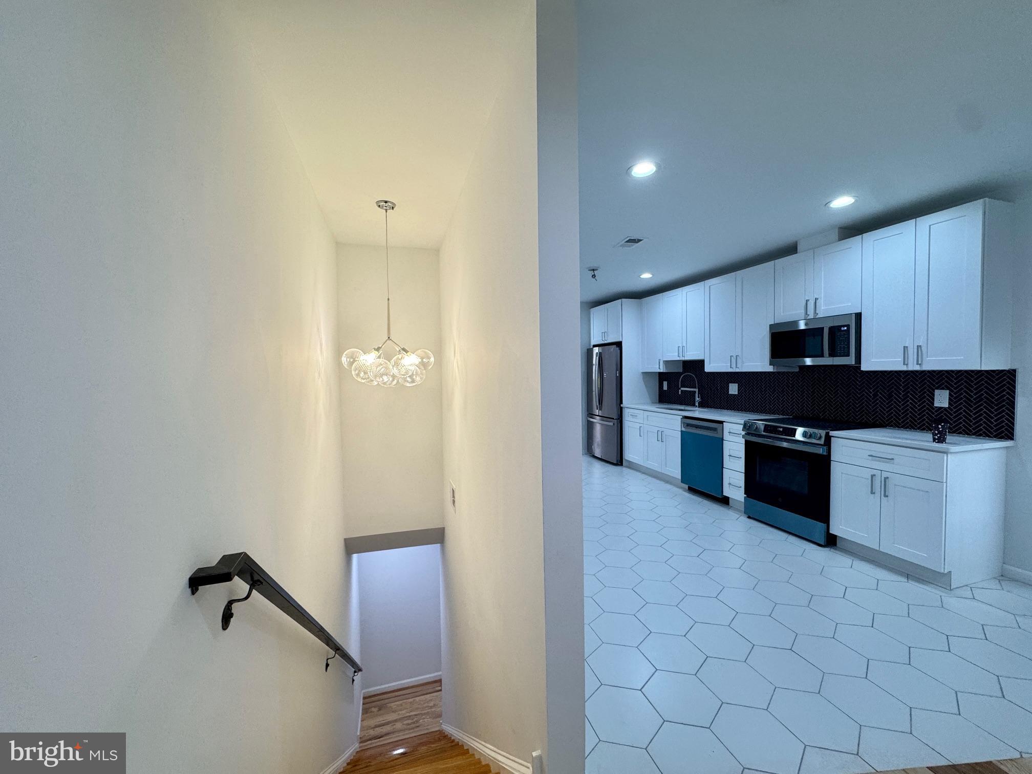 781 South 3rd Street, Unit 3 Philadelphia, PA 19147 - Photo 3 of 17 a kitchen with granite countertop a refrigerator and a stove top oven