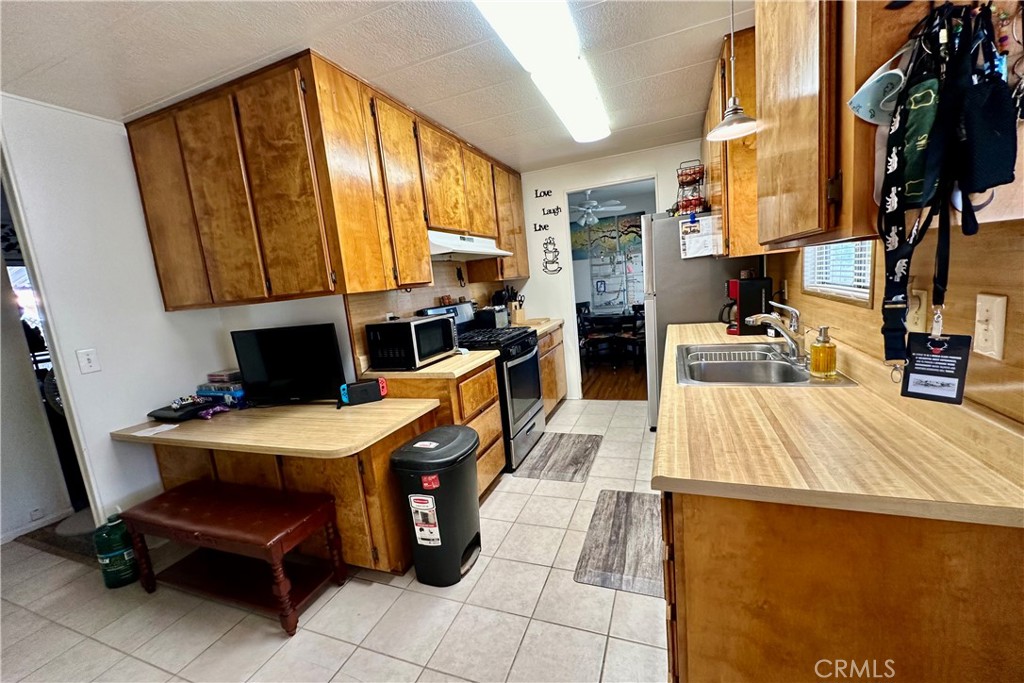 3745 Valley Boulevard, Unit 12 Walnut, CA 91789 - Photo 15 of 43 a room with a table chairs and a refrigerator