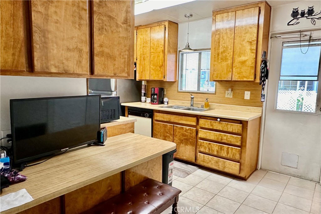 3745 Valley Boulevard, Unit 12 Walnut, CA 91789 - Photo 17 of 43 a kitchen with stainless steel appliances a stove a sink and a microwave