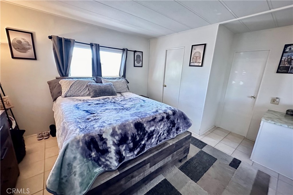 3745 Valley Boulevard, Unit 12 Walnut, CA 91789 - Photo 20 of 43 a bedroom with a large bed couch and window