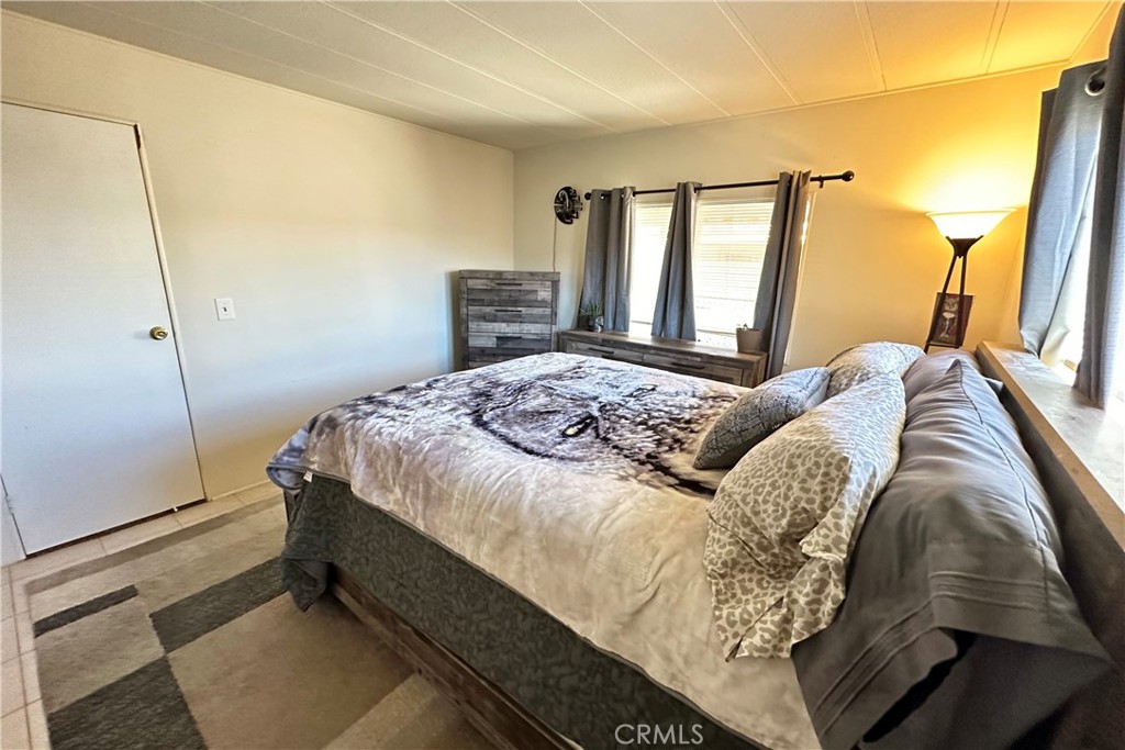 3745 Valley Boulevard, Unit 12 Walnut, CA 91789 - Photo 21 of 43 a bedroom with a bed and a window