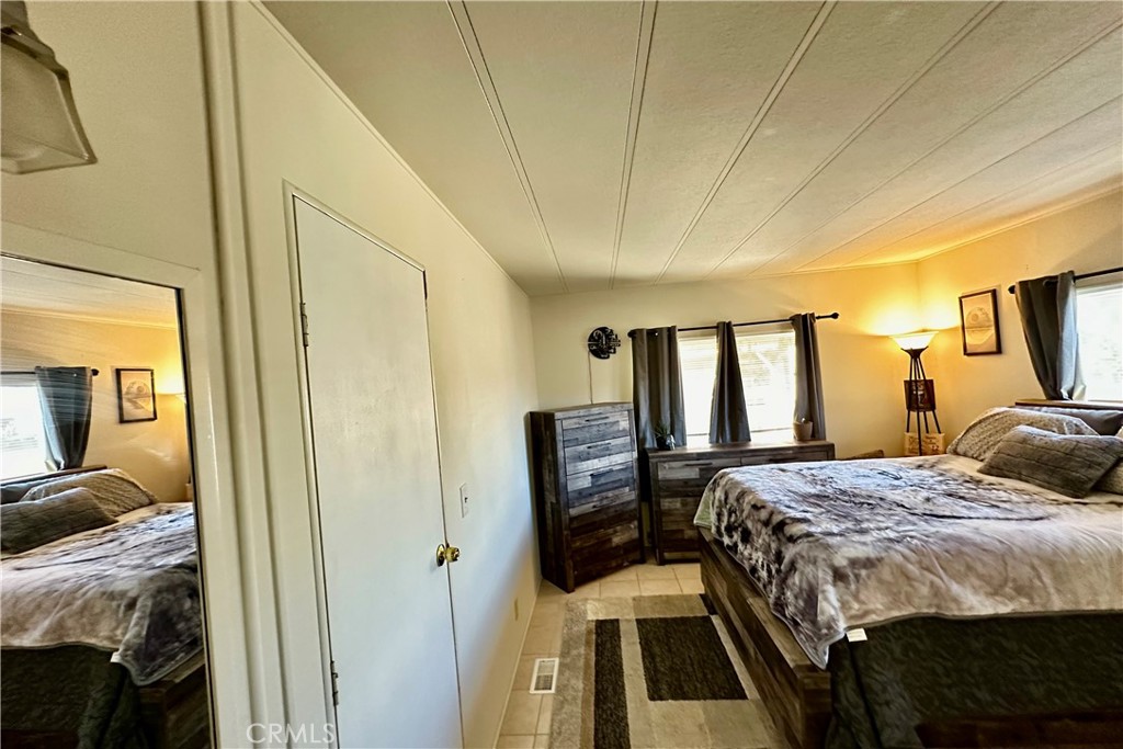 3745 Valley Boulevard, Unit 12 Walnut, CA 91789 - Photo 22 of 43 a bedroom with a bed and wooden floor