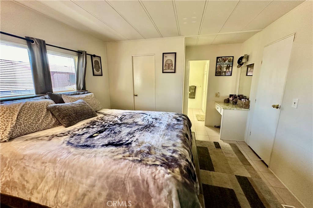 3745 Valley Boulevard, Unit 12 Walnut, CA 91789 - Photo 23 of 43 a bedroom with a bed and wooden floor