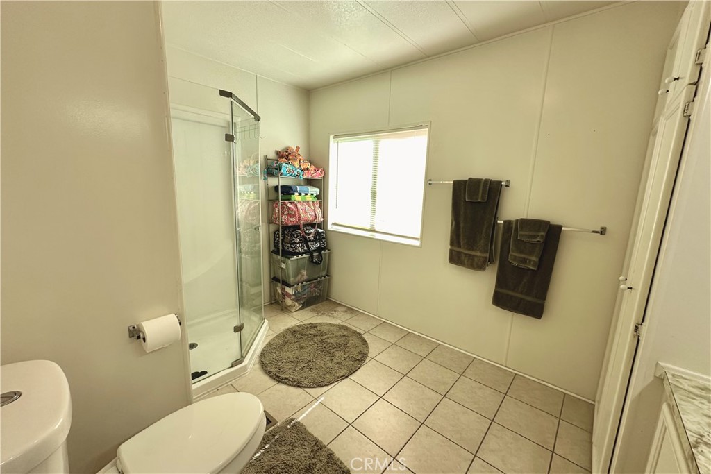 3745 Valley Boulevard, Unit 12 Walnut, CA 91789 - Photo 25 of 43 a bathroom with a sink toilet and mirror