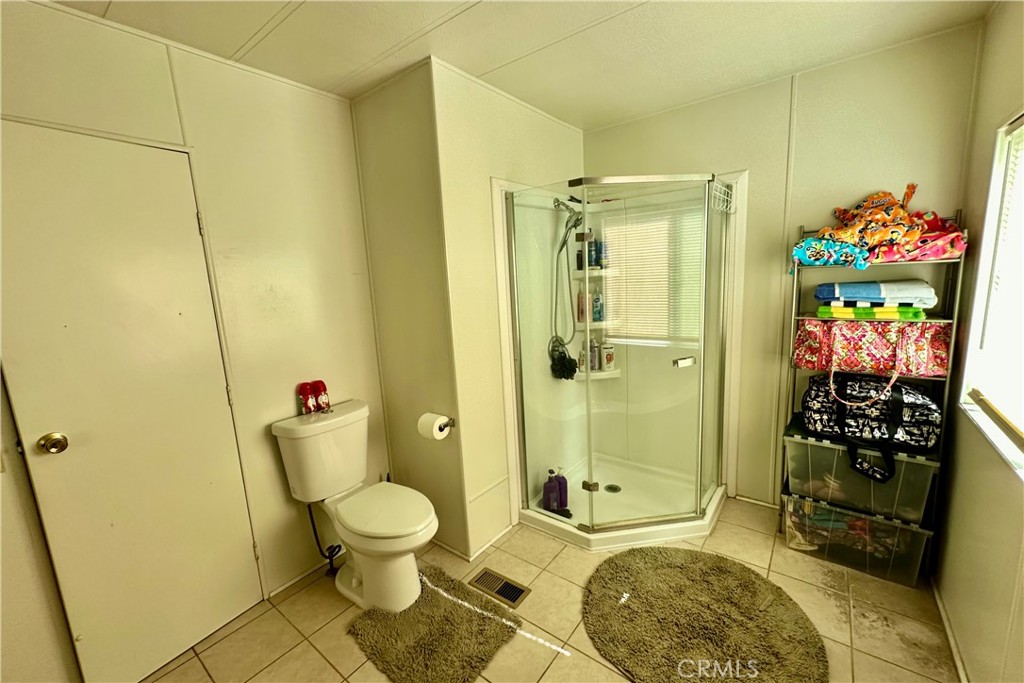 3745 Valley Boulevard, Unit 12 Walnut, CA 91789 - Photo 26 of 43 a bathroom with a toilet a sink and shower