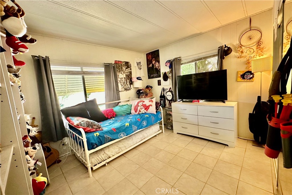 3745 Valley Boulevard, Unit 12 Walnut, CA 91789 - Photo 29 of 43 a living room with furniture and a flat screen tv