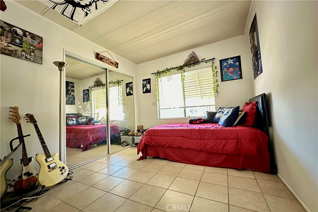 3745 Valley Boulevard, Unit 12 Walnut, CA 91789 - Photo 30 of 43 a room with a bed and a mirror