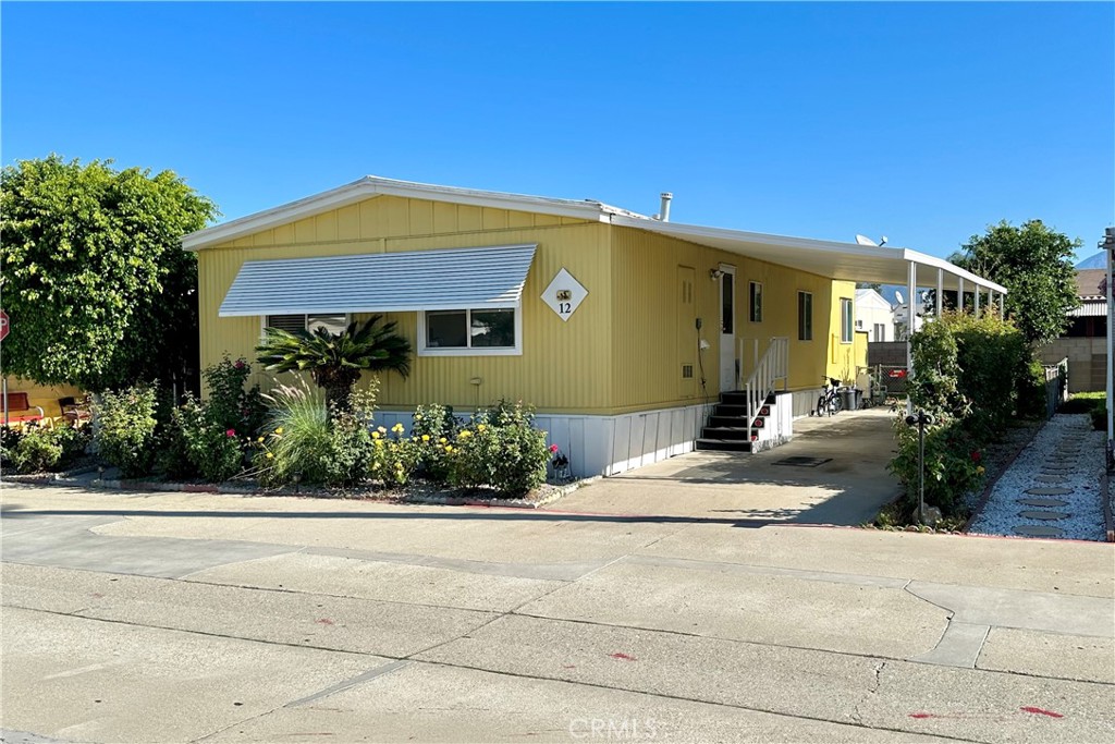 3745 Valley Boulevard, Unit 12 Walnut, CA 91789 - Photo 3 of 43 a front view of a house with garden