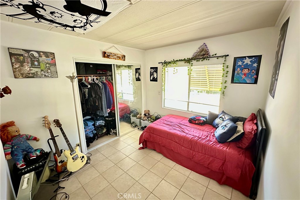 3745 Valley Boulevard, Unit 12 Walnut, CA 91789 - Photo 33 of 43 a bedroom with furniture and a flat screen tv