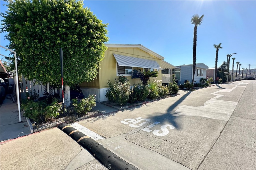 3745 Valley Boulevard, Unit 12 Walnut, CA 91789 - Photo 5 of 43 a view of a house with backyard and bushes
