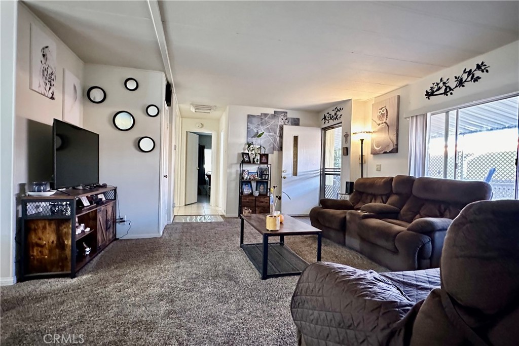 3745 Valley Boulevard, Unit 12 Walnut, CA 91789 - Photo 10 of 43 a living room with furniture and a flat screen tv