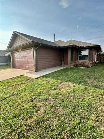 a view of a house with a yard and garage