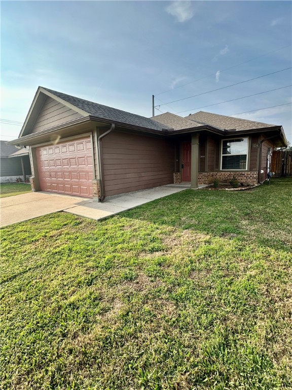 a view of a house with a yard and garage
