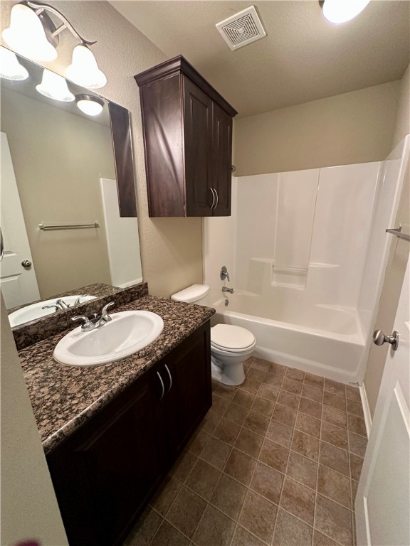 1134 Cottage Grove Circle Bryan, TX 77801 - Photo 13 of 22 a bathroom with a granite countertop sink a toilet and a mirror